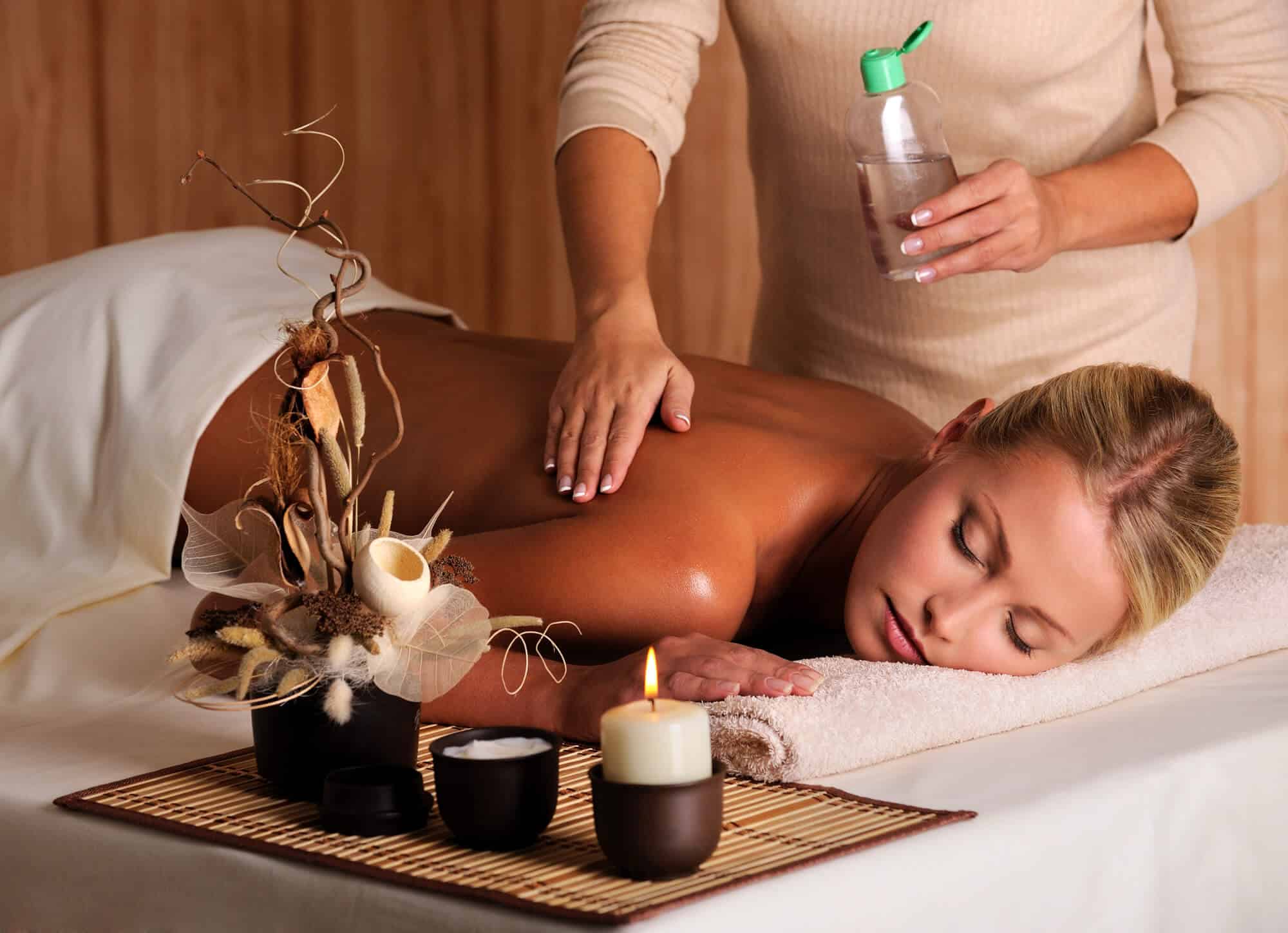 Massage therapist applying oil